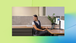 A woman sitting at a desk with a computer